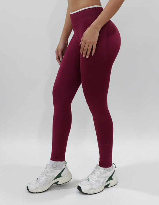 Red wine seamless leggings with white piping featuring a supportive high waist, invisible scrunch butt, and butt lifting compression, perfect for gym, squat proof workouts, and fitness.