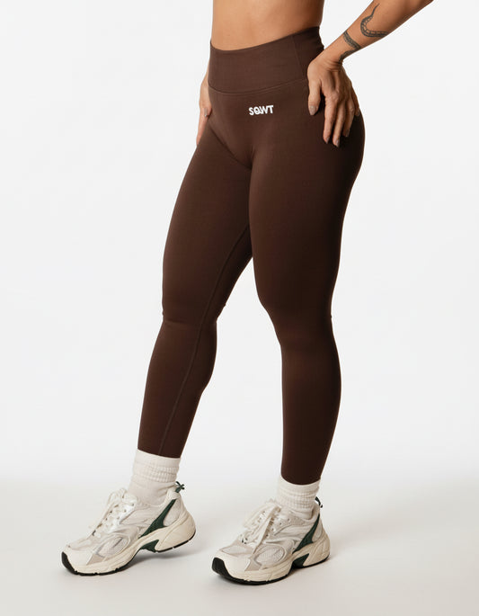 Dark brown high-waisted seamless scrunch-butt leggings with a wide waistband and subtle "SQWT" logo on the hip, shown from both side and back views.