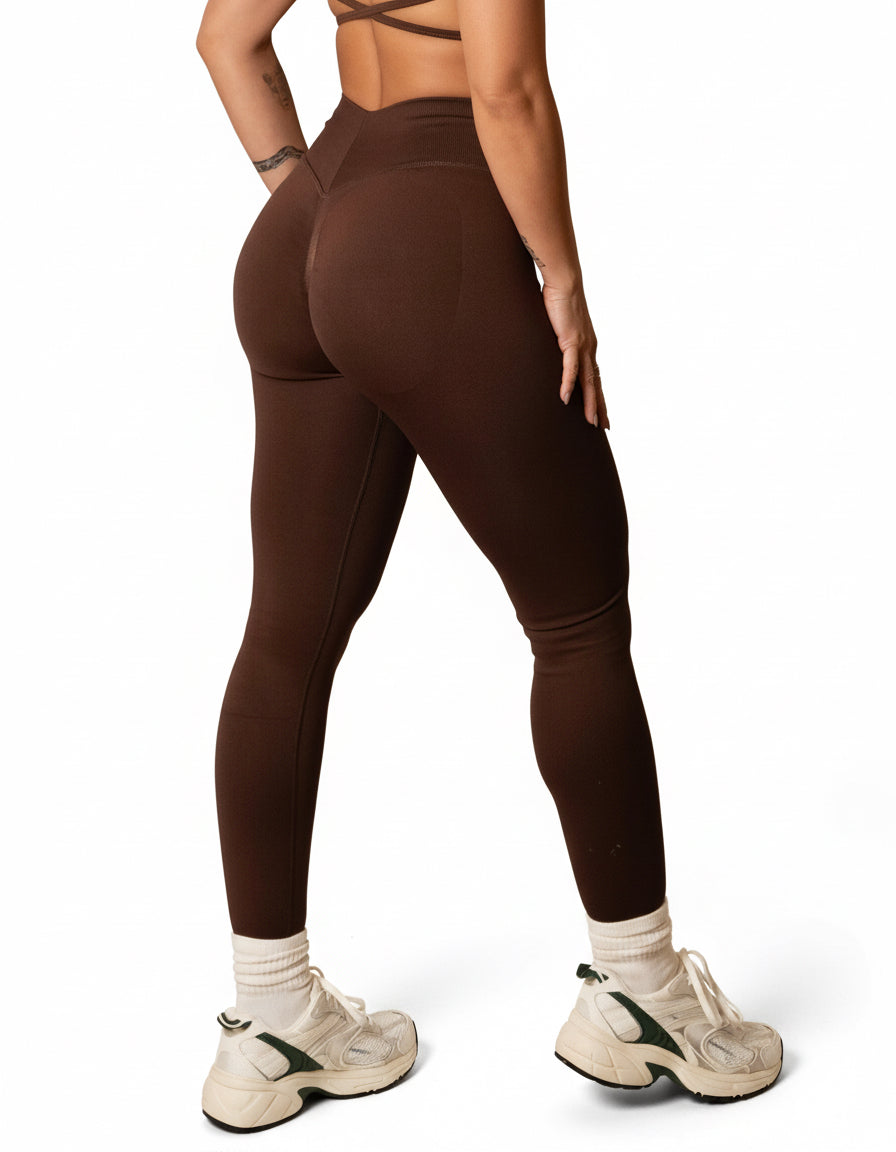 Dark brown high-waisted seamless scrunch-butt leggings with a wide waistband and subtle "SQWT" logo on the hip, shown from both side and back views.