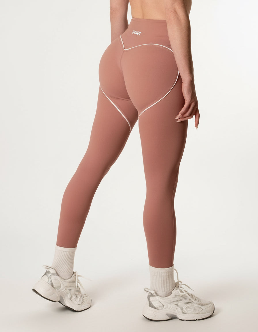 SQWT ContourHeart dusty pink high-waist leggings for women. White contour lines enhance glutes. Squat-proof fitness wear.