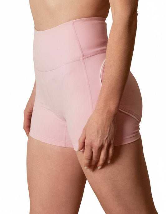 Seamless high-waisted gym shorts in baby pink, featuring a wide V-shaped back waistband with white contrast piping/seaming that enhances the booty shape.