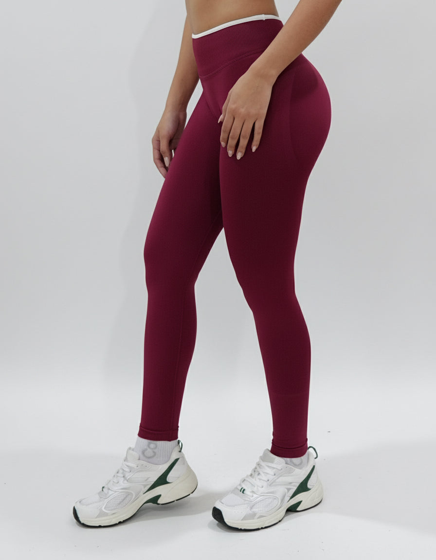 Red wine seamless leggings with white piping featuring a supportive high waist, invisible scrunch butt, and butt lifting compression, perfect for gym, squat proof workouts, and fitness.