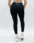 Black seamless leggings with white piping featuring a supportive high waist, invisible scrunch butt, and butt lifting compression, perfect for gym, squat proof workouts, and fitness.