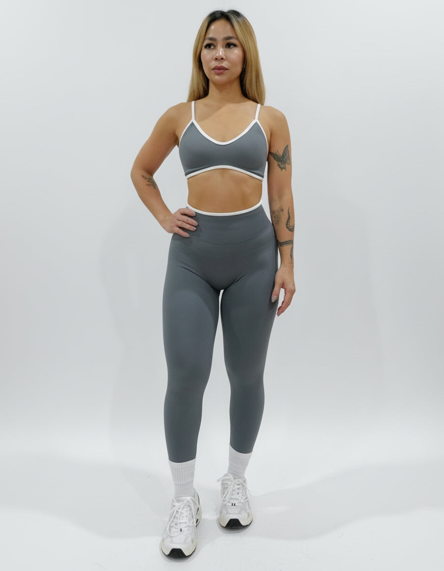 Dark grey seamless leggings with white piping featuring a supportive high waist, invisible scrunch butt, and butt lifting compression, perfect for gym, squat proof workouts, and fitness.