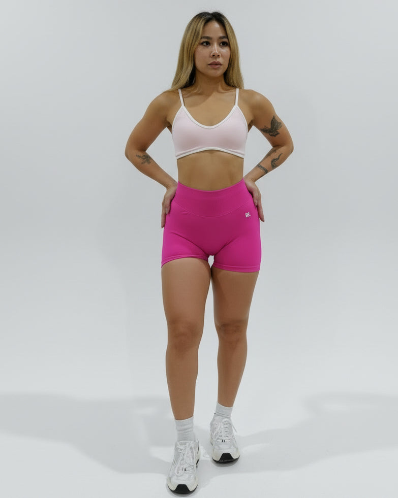 Fuchsia seamless high-waisted scrunch gym shorts with a V-shaped back waistband.