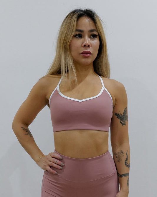 SQWT ContourHeart Bra in dusty pink, a light-compression workout bra for women with white trim, scoop neck, and unique Y-back strap design for yoga, Pilates, and everyday comfort.