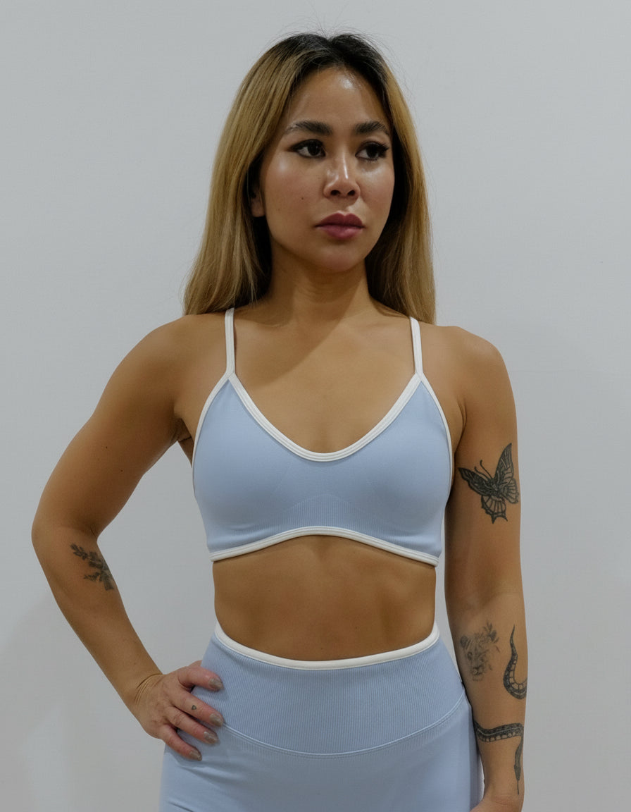 SQWT seamless baby blue sports bra with white contrast for women. Medium support gym bra designed to lift and enhance breasts. Ideal for workouts