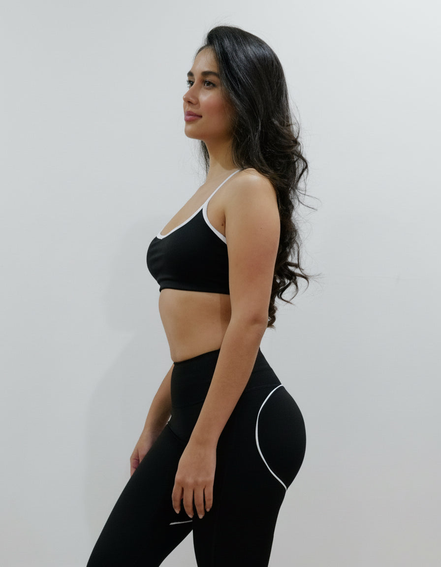 SQWT ContourHeart  Bra in Black, a light-compression workout bra for women with white trim, scoop neck, and unique Y-back strap design for yoga, Pilates, and everyday comfort.