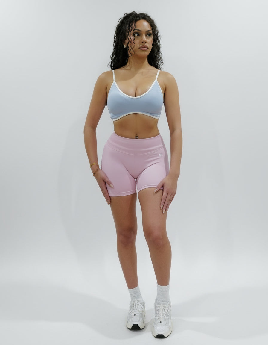 Baby pink seamless high-waisted scrunch gym shorts with a V-shaped back waistband.