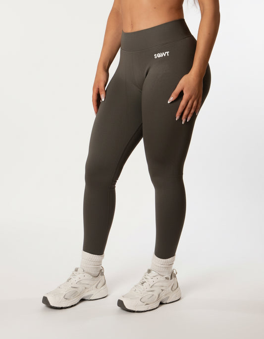 Dark grey high-waisted seamless scrunch-butt leggings with a wide waistband and subtle "SQWT" logo on the hip, shown from both side and back view