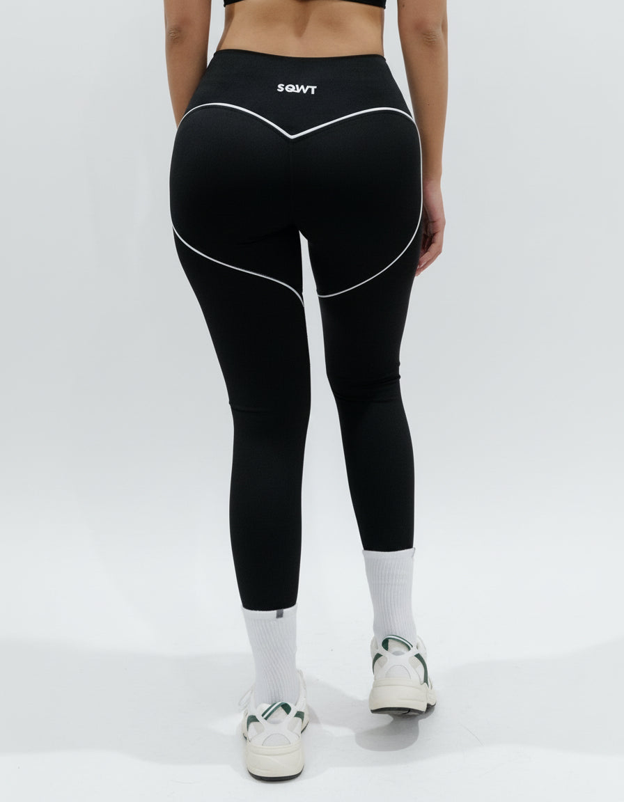SQWT ContourHeart black high-waist leggings for women. White contour lines enhance glutes. Squat-proof fitness wear.